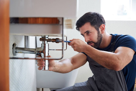 man working under sink