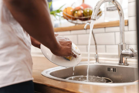man washing dishes