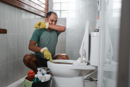 man working on toilet